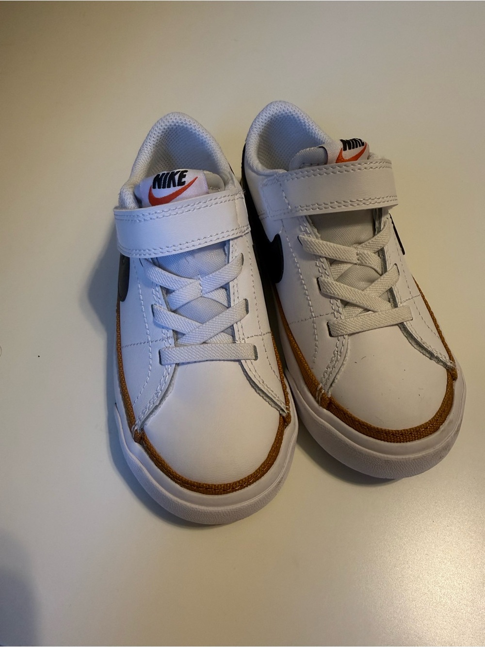 Nike Kids White Sneakers with Brown Trim and Black Swoosh
